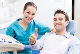 Dentist and Patient in a Dental Chair Smiling